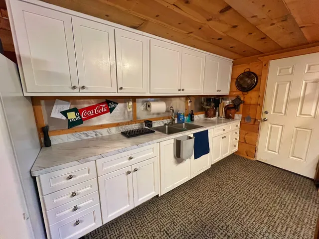 a kitchen with stainless steel appliances granite countertop a sink a stove and cabinets