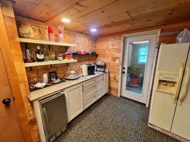 a kitchen with stainless steel appliances granite countertop a refrigerator a stove a sink and dishwasher