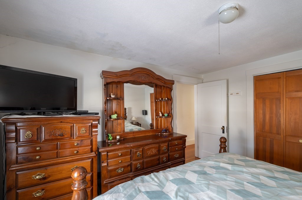 61 Bridge Road Northampton, MA 01062 - Photo 19 of 34 a bedroom with a bed and a flat tv screen on dresser