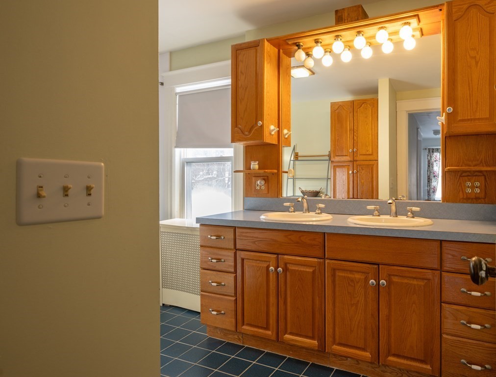 61 Bridge Road Northampton, MA 01062 - Photo 24 of 34 a bathroom with a double vanity sink and a mirror