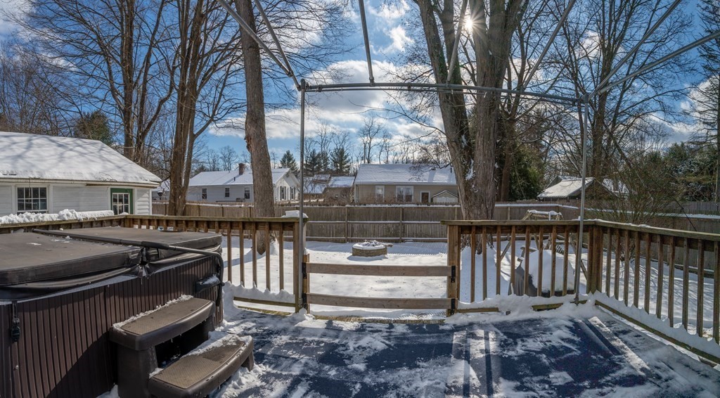 61 Bridge Road Northampton, MA 01062 - Photo 28 of 34 a view of a patio with table and chairs under an umbrella with large trees