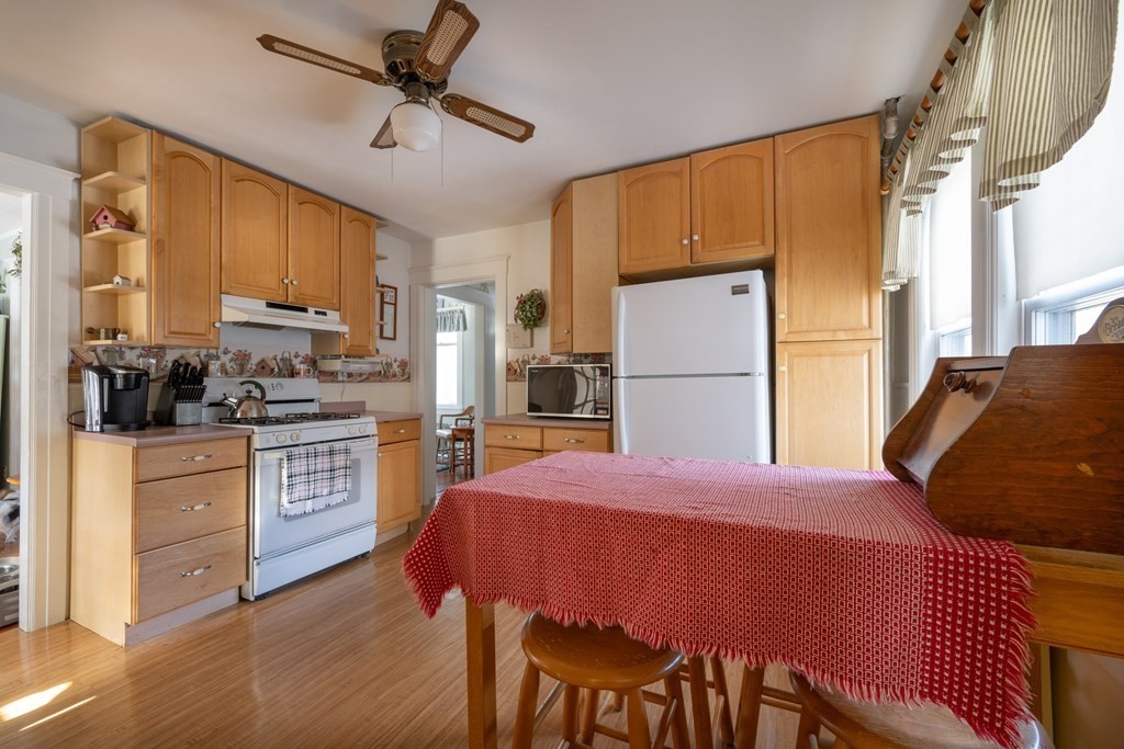 61 Bridge Road Northampton, MA 01062 - Photo 8 of 34 a kitchen with a refrigerator a stove top oven a sink and cabinets