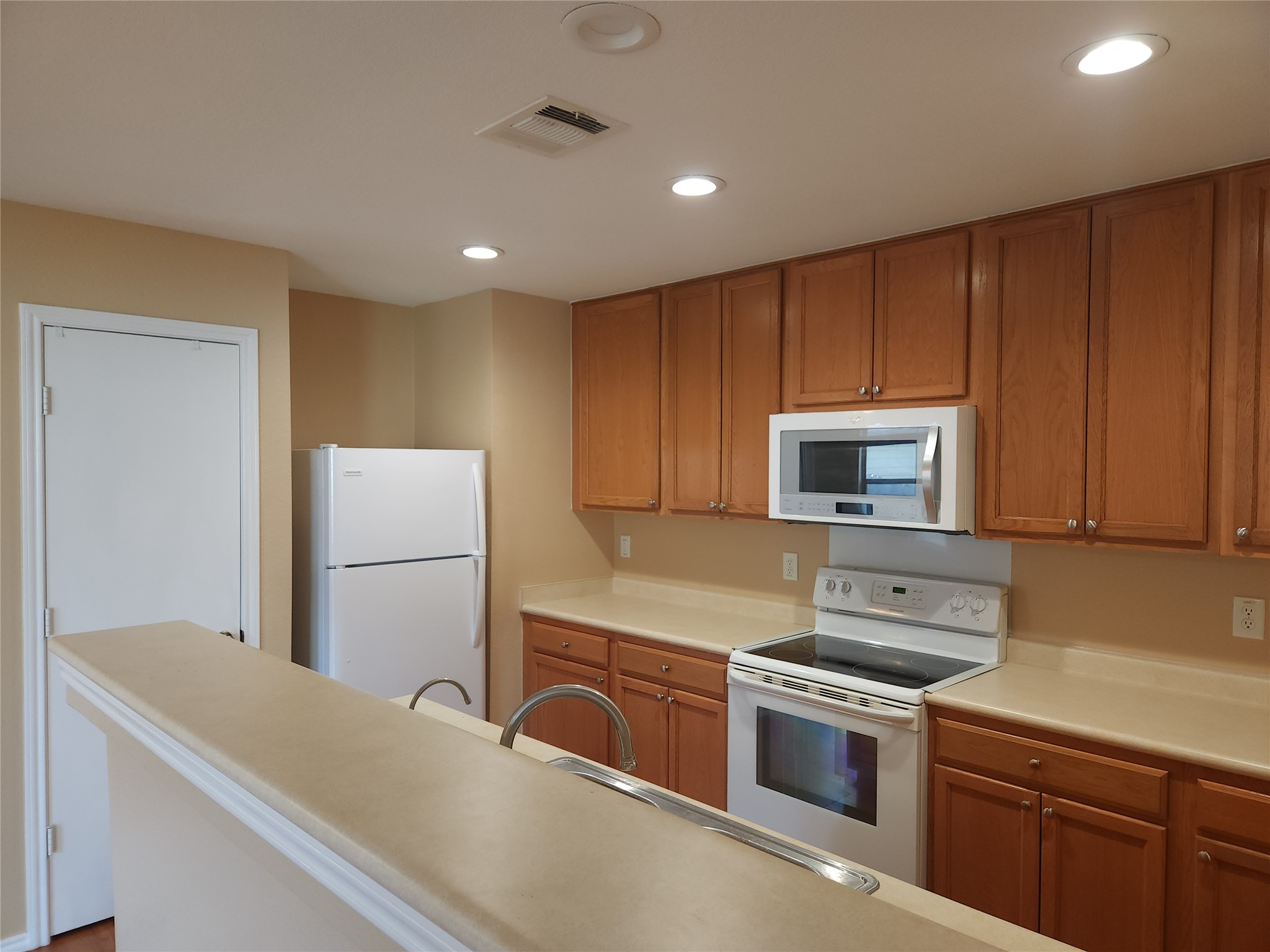 273 Tower Drive Kyle, TX 78640 - Photo 4 of 13 a kitchen with a refrigerator sink and microwave