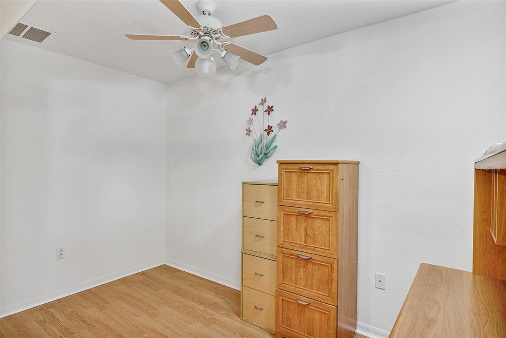11447 Southwest 69th Circle Ocala, FL 34476 - Photo 11 of 32 an empty room with wooden floor closet and windows
