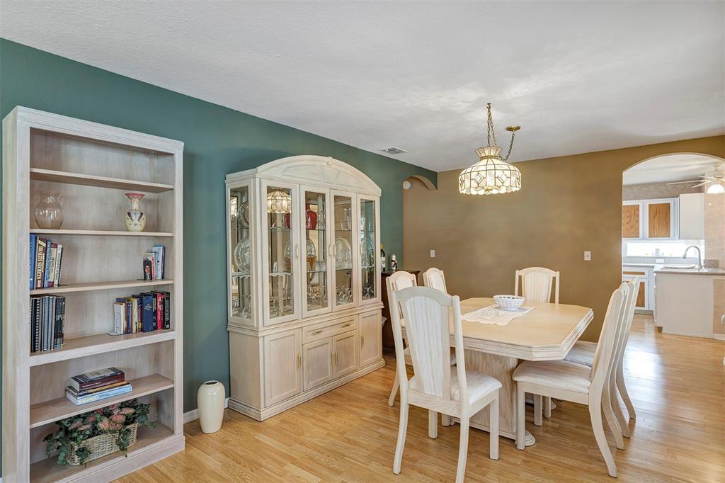 11447 Southwest 69th Circle Ocala, FL 34476 - Photo 13 of 32 a view of a dining room with furniture window and wooden floor