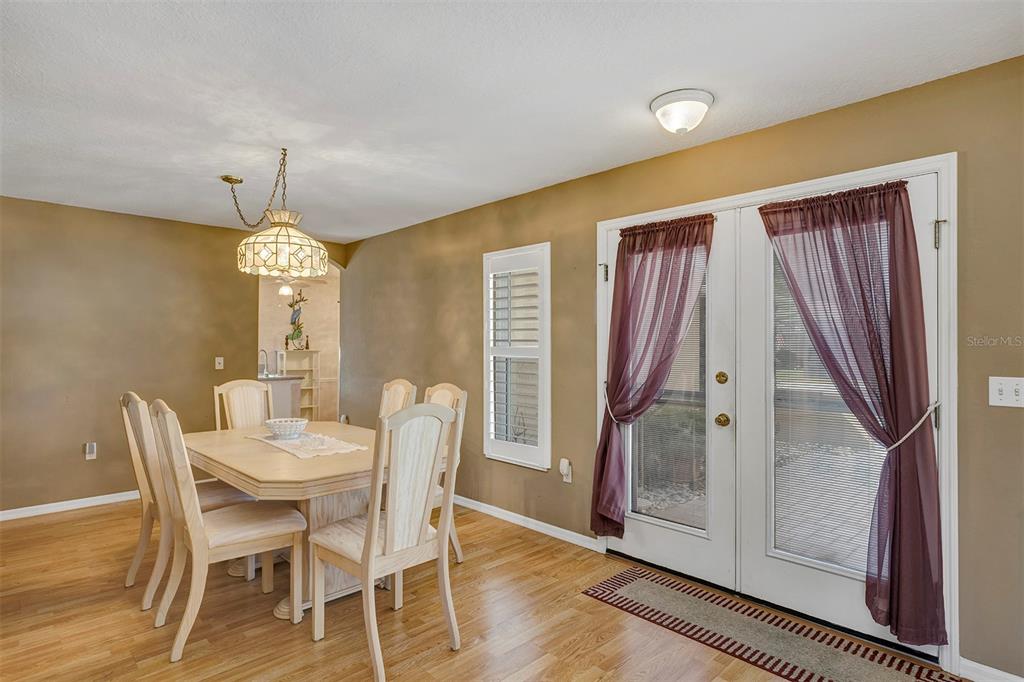 11447 Southwest 69th Circle Ocala, FL 34476 - Photo 14 of 32 a view of a dining room with furniture window and wooden floor