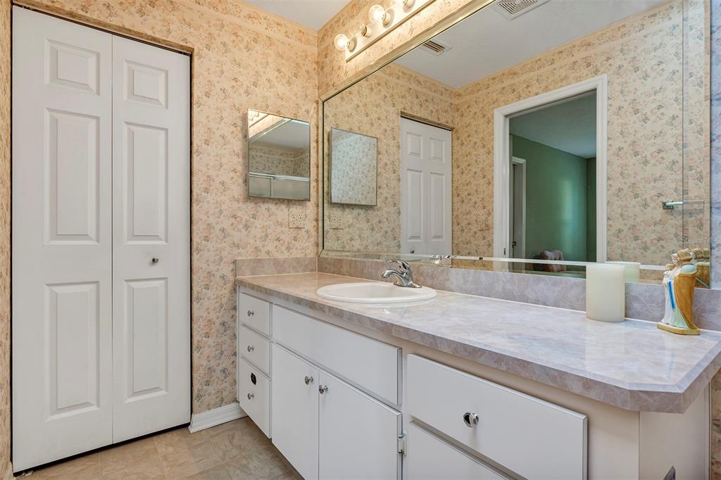 11447 Southwest 69th Circle Ocala, FL 34476 - Photo 18 of 32 a bathroom with a granite countertop sink and a mirror