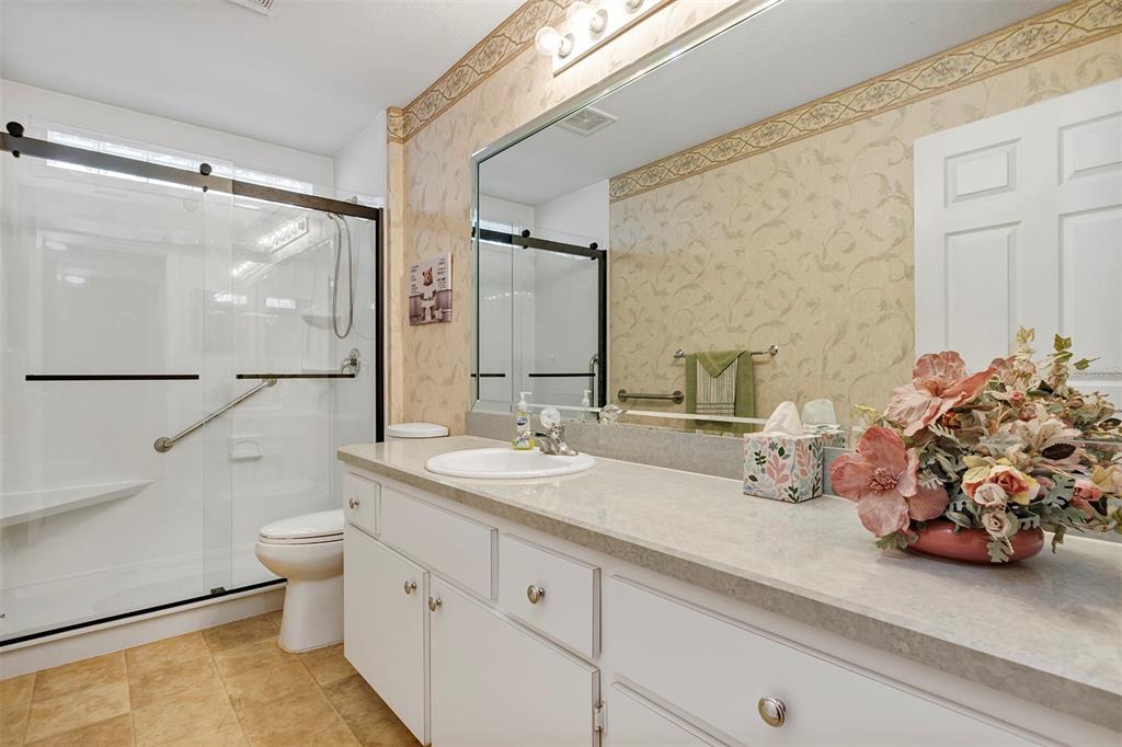 11447 Southwest 69th Circle Ocala, FL 34476 - Photo 21 of 32 a bathroom with a double vanity sink mirror and toilet