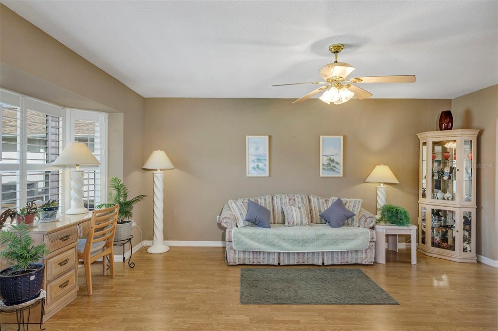 11447 Southwest 69th Circle Ocala, FL 34476 - Photo 23 of 32 a living room with furniture and a chandelier