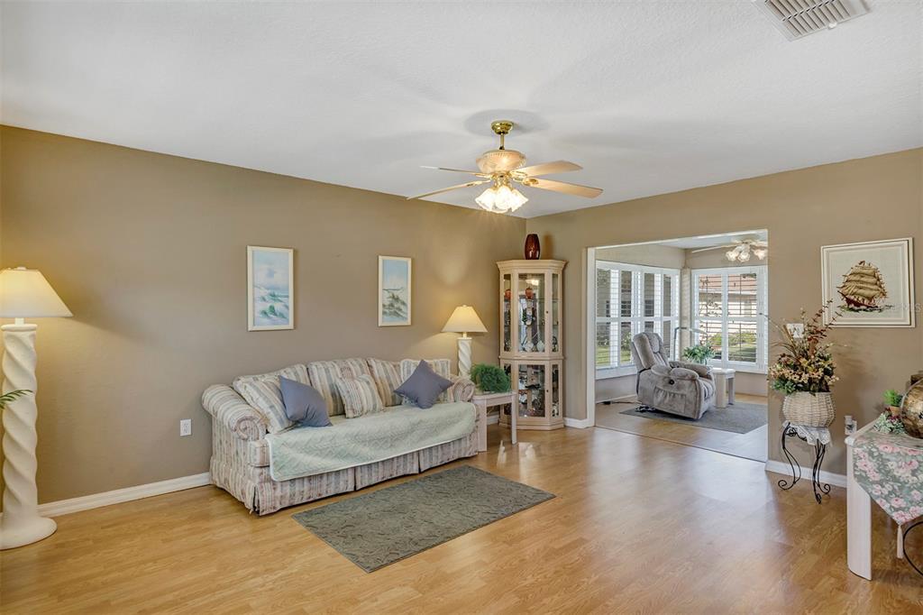 11447 Southwest 69th Circle Ocala, FL 34476 - Photo 24 of 32 a living room with furniture and wooden floor