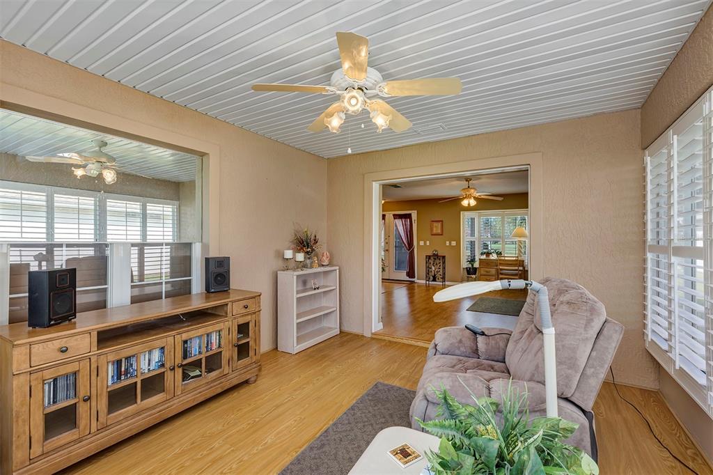 11447 Southwest 69th Circle Ocala, FL 34476 - Photo 26 of 32 a living room with furniture and a flat screen tv