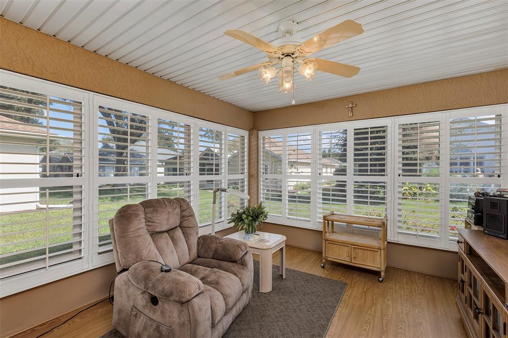 11447 Southwest 69th Circle Ocala, FL 34476 - Photo 27 of 32 a living room with furniture and a floor to ceiling window