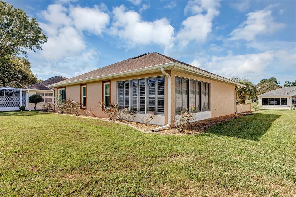 11447 Southwest 69th Circle Ocala, FL 34476 - Photo 28 of 32 a front view of a house with garden