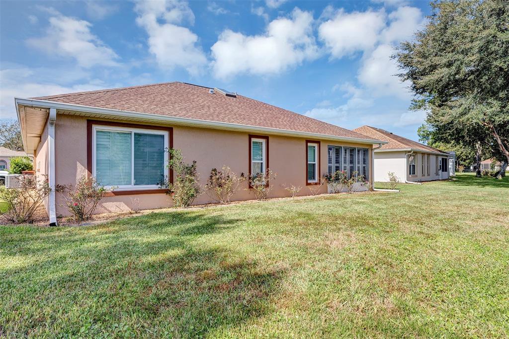 11447 Southwest 69th Circle Ocala, FL 34476 - Photo 30 of 32 a front view of a house with a yard