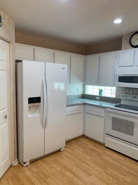 11447 Southwest 69th Circle Ocala, FL 34476 - Photo 5 of 32 a white refrigerator freezer sitting inside of a kitchen