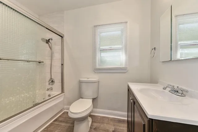 a bathroom with a sink toilet and shower