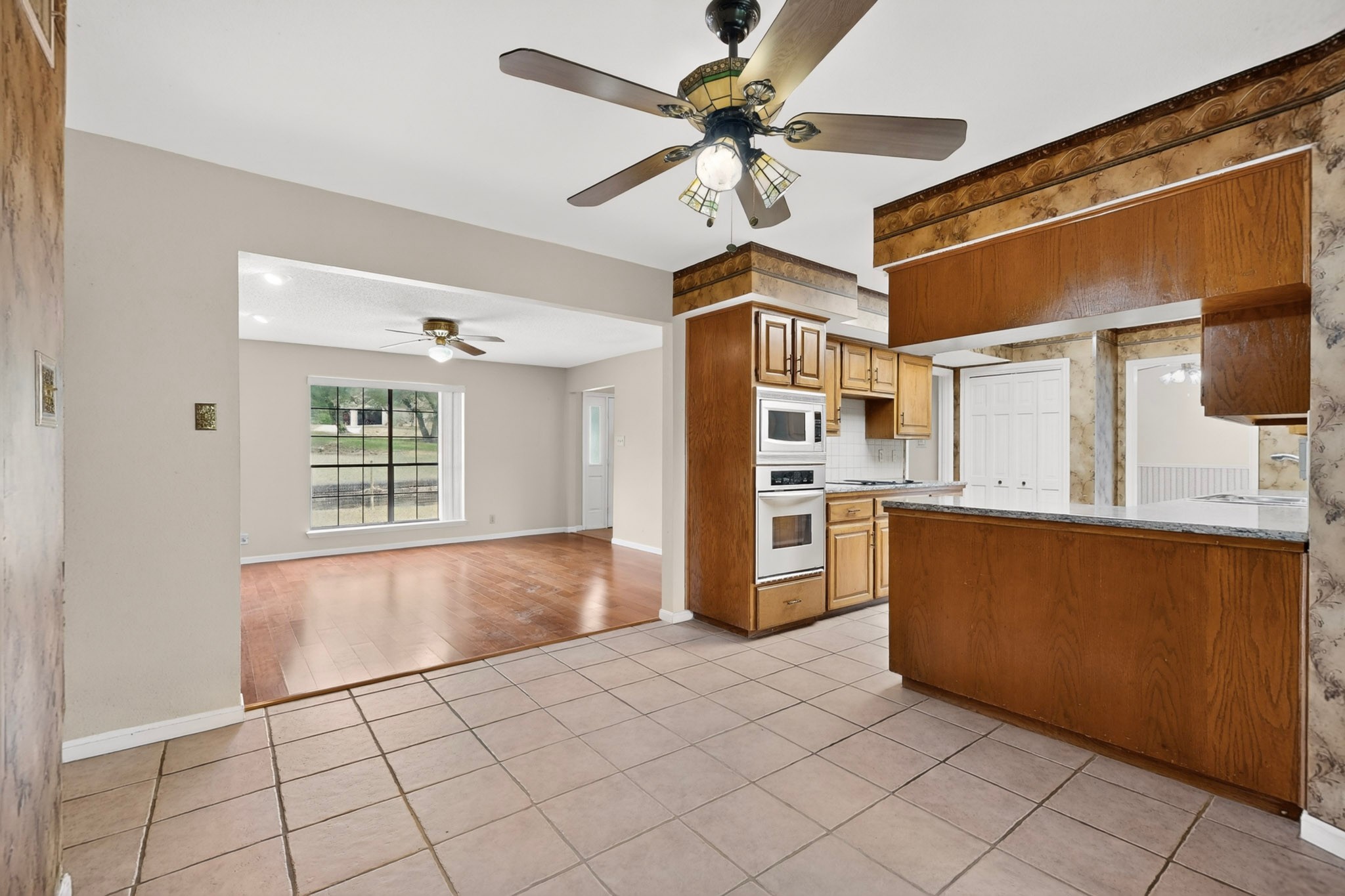 1003 Pier Branch Road Dripping Springs, TX 78620 - Photo 22 of 40 A well-appointed kitchen features ample cabinetry and integrated appliances, flowing into a bright living area.