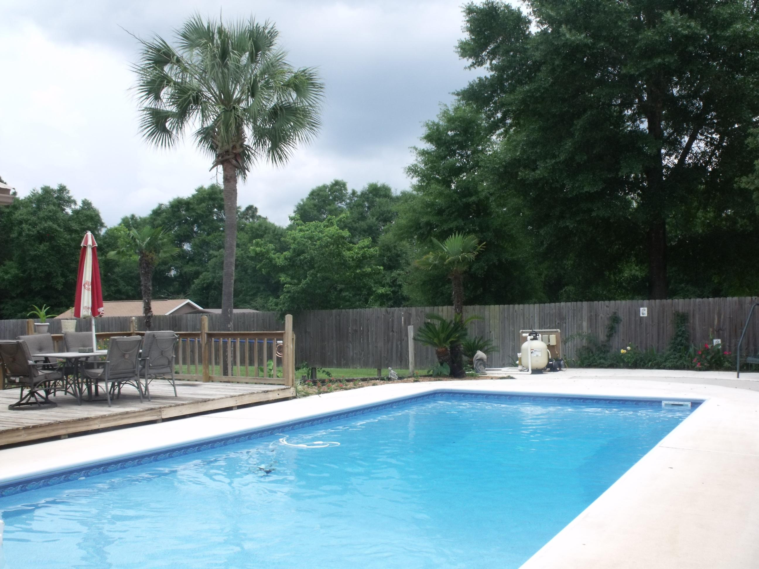 6047 Eden Square Crestview, FL 32539 - Photo 2 of 22 a swimming pool with lake view