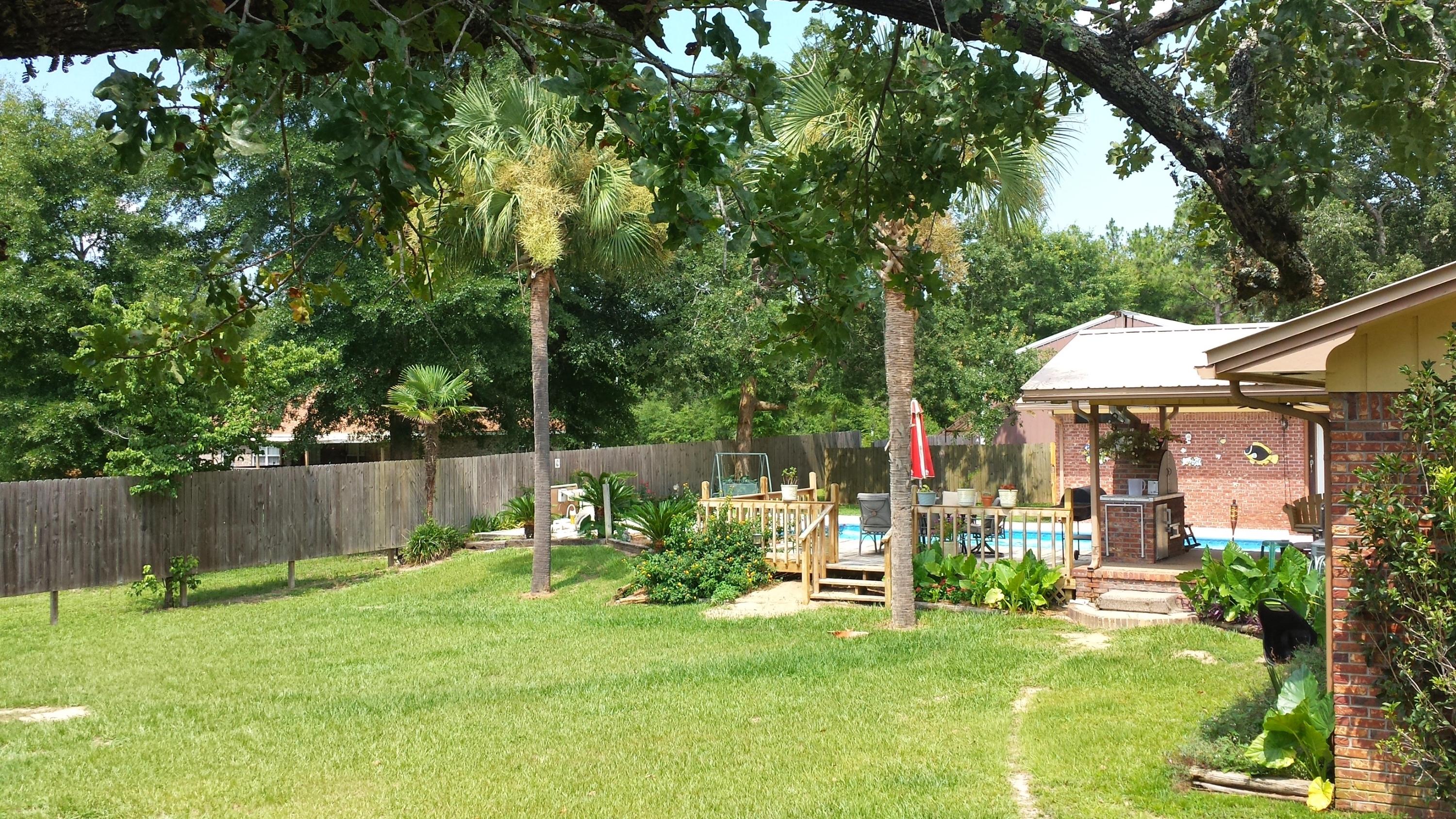 6047 Eden Square Crestview, FL 32539 - Photo 3 of 22 a view of a chair and table in backyard of the house