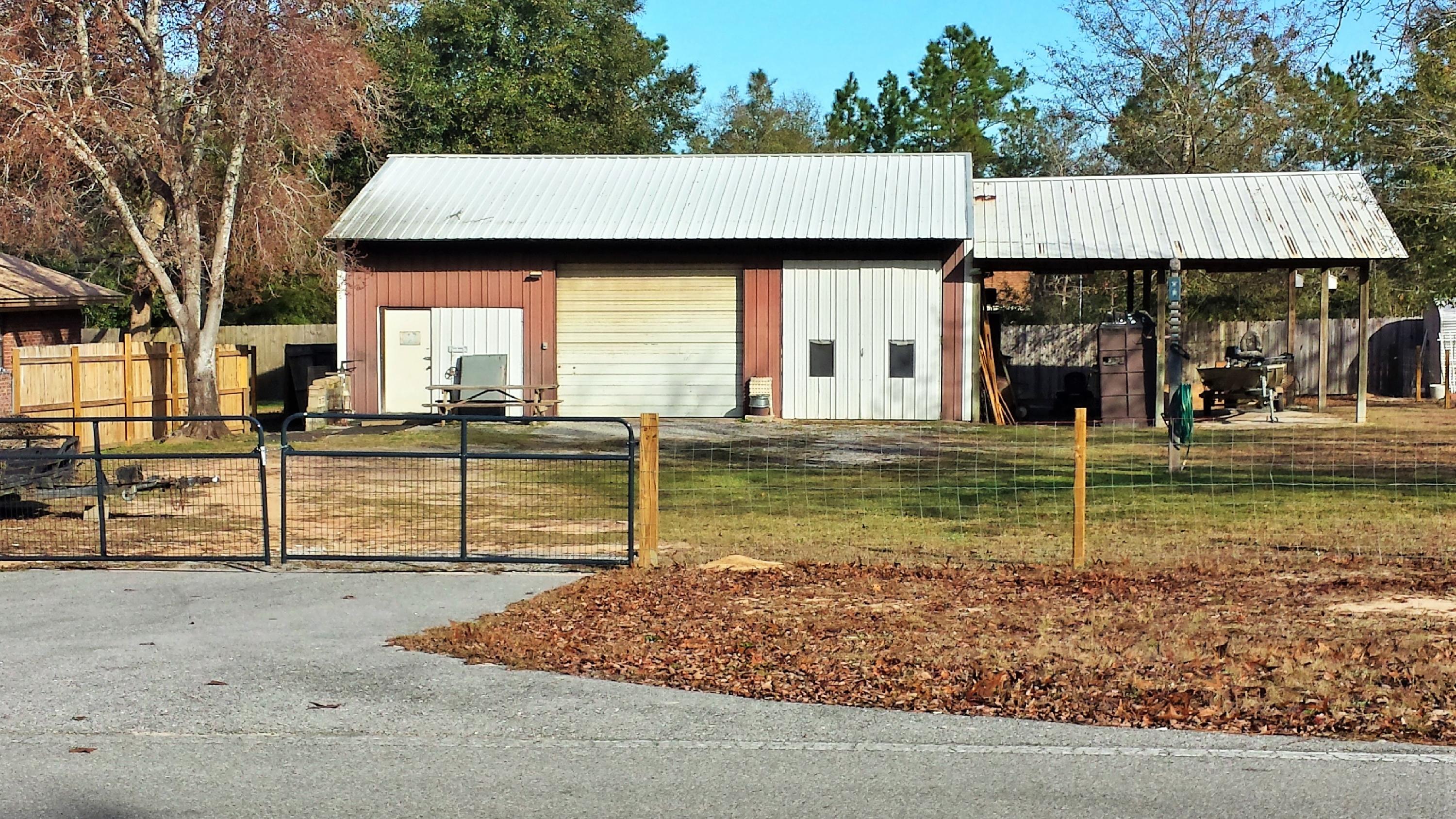 6047 Eden Square Crestview, FL 32539 - Photo 21 of 22 a view of a house with backyard and trees