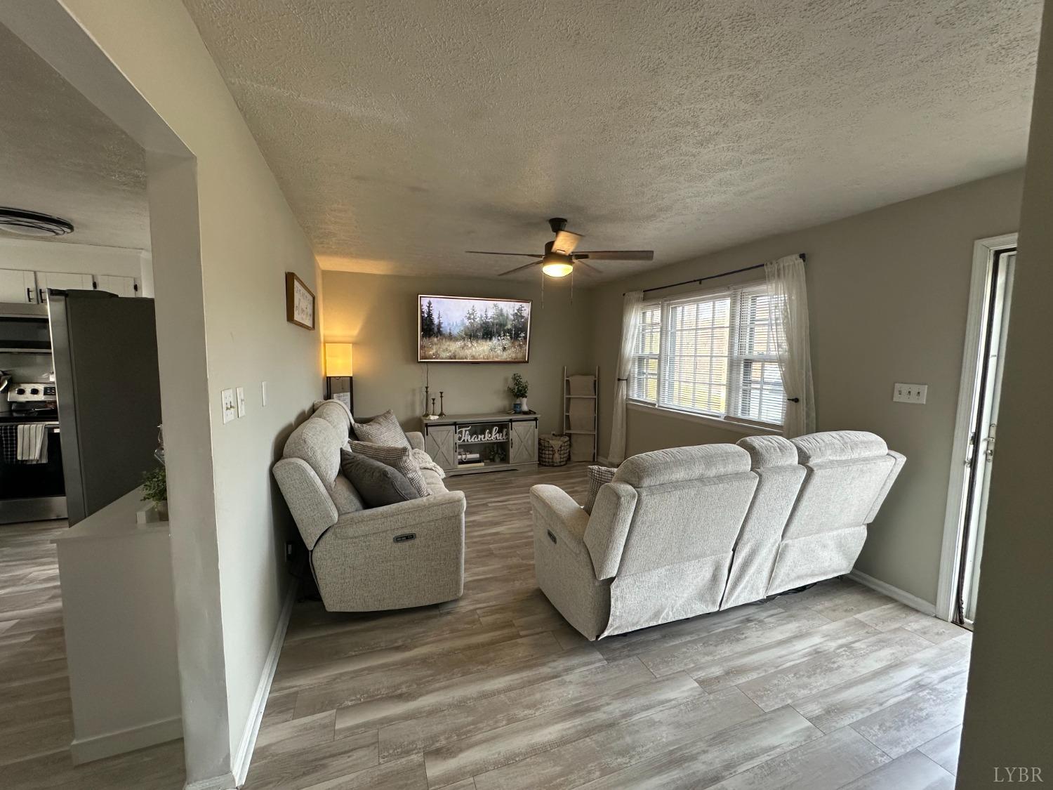 428 Thomas Road Madison Heights, VA 24572 - Photo 5 of 10 a living room with furniture and a flat screen tv