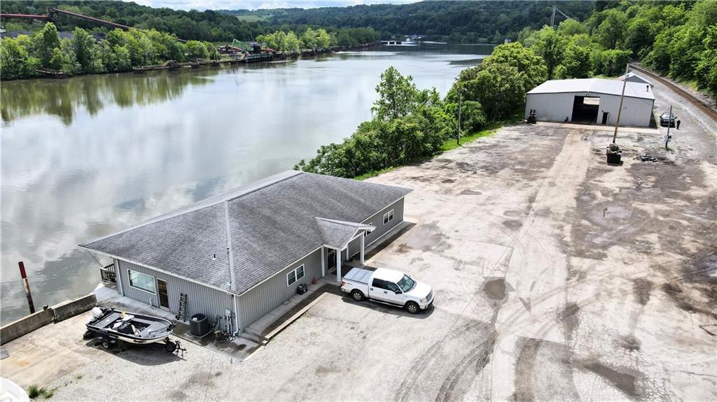a aerial view of a house with a yard and lake view