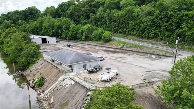 an aerial view of a house with a yard and trees