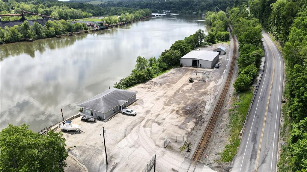 736 Front Street Fredericktown, PA 15333 - Photo 6 of 41 a view of a lake with a yard and mountain view