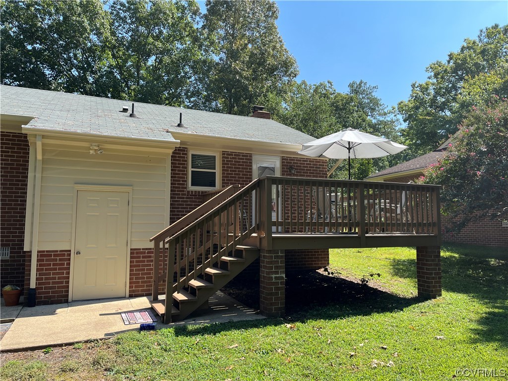 5036 Rollingway Road Chesterfield, VA 23832 - Photo 11 of 42 a view of a house with wooden deck and a backyard
