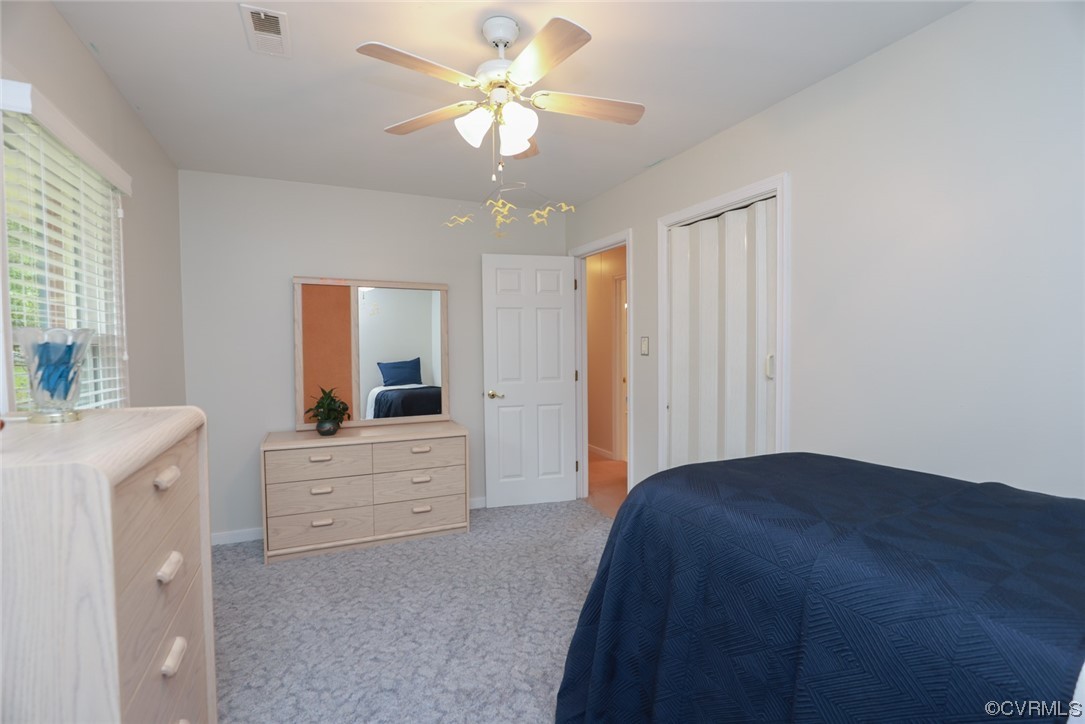 5036 Rollingway Road Chesterfield, VA 23832 - Photo 31 of 42 a bedroom with a bed and a chandelier