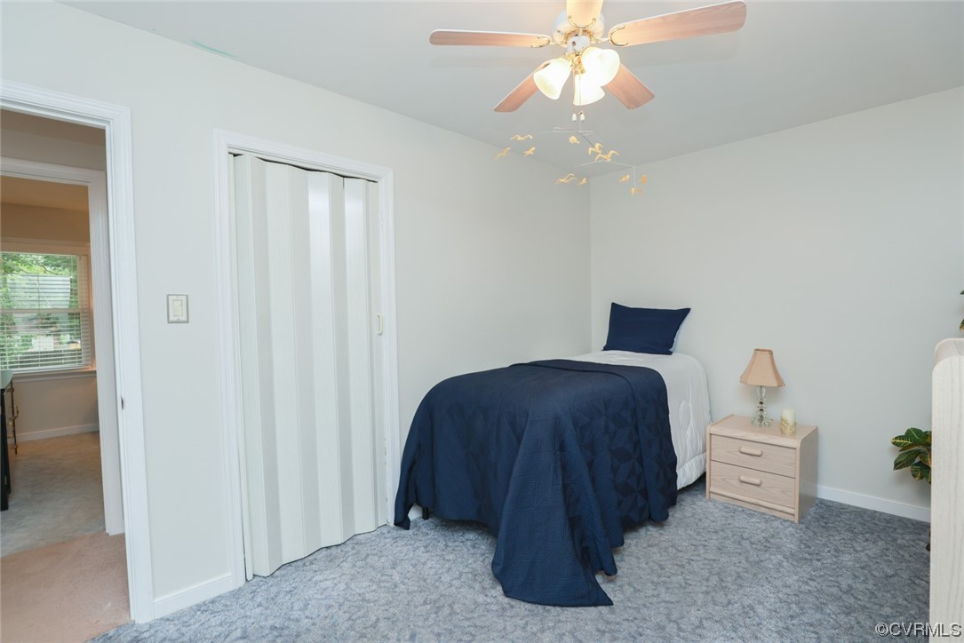 5036 Rollingway Road Chesterfield, VA 23832 - Photo 32 of 42 a bedroom with a bed and a chandelier
