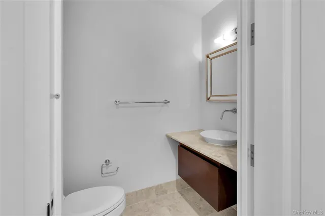 a bathroom with a sink toilet and mirror