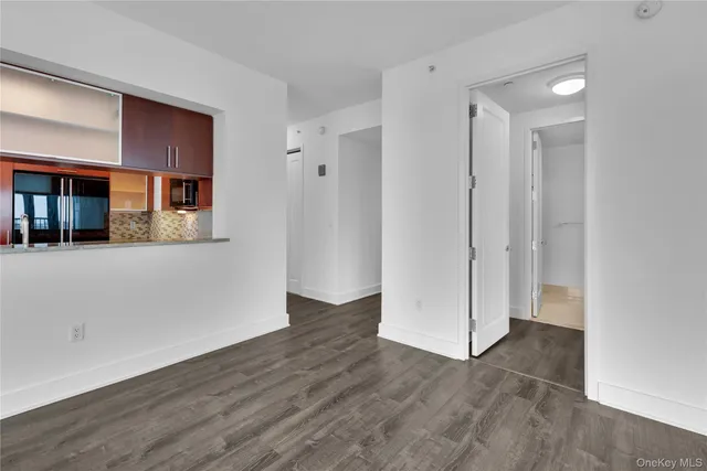 a view of a room with wooden floor