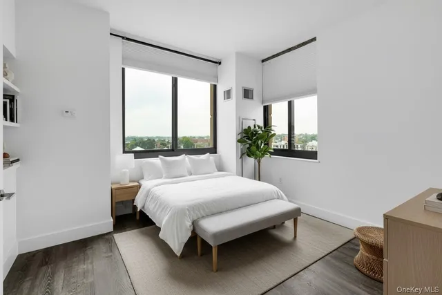 a bed sitting in a bedroom next to a window