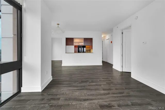 a view of a room with wooden floor and window