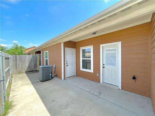 a view of a house with backyard porch and sitting area