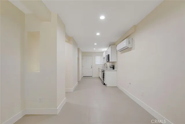 a kitchen with granite countertop white cabinets sink and stainless steel appliances