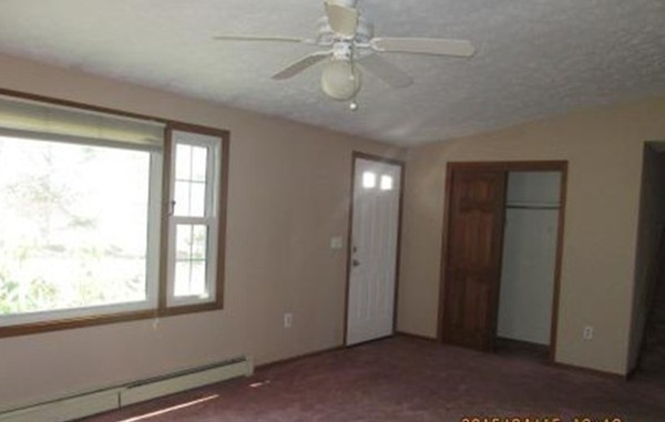 266 Pommogussett Road Rutland, MA 01543 - Photo 8 of 13 an empty room with windows and fan