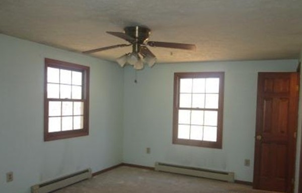 266 Pommogussett Road Rutland, MA 01543 - Photo 10 of 13 an empty room with windows and fan