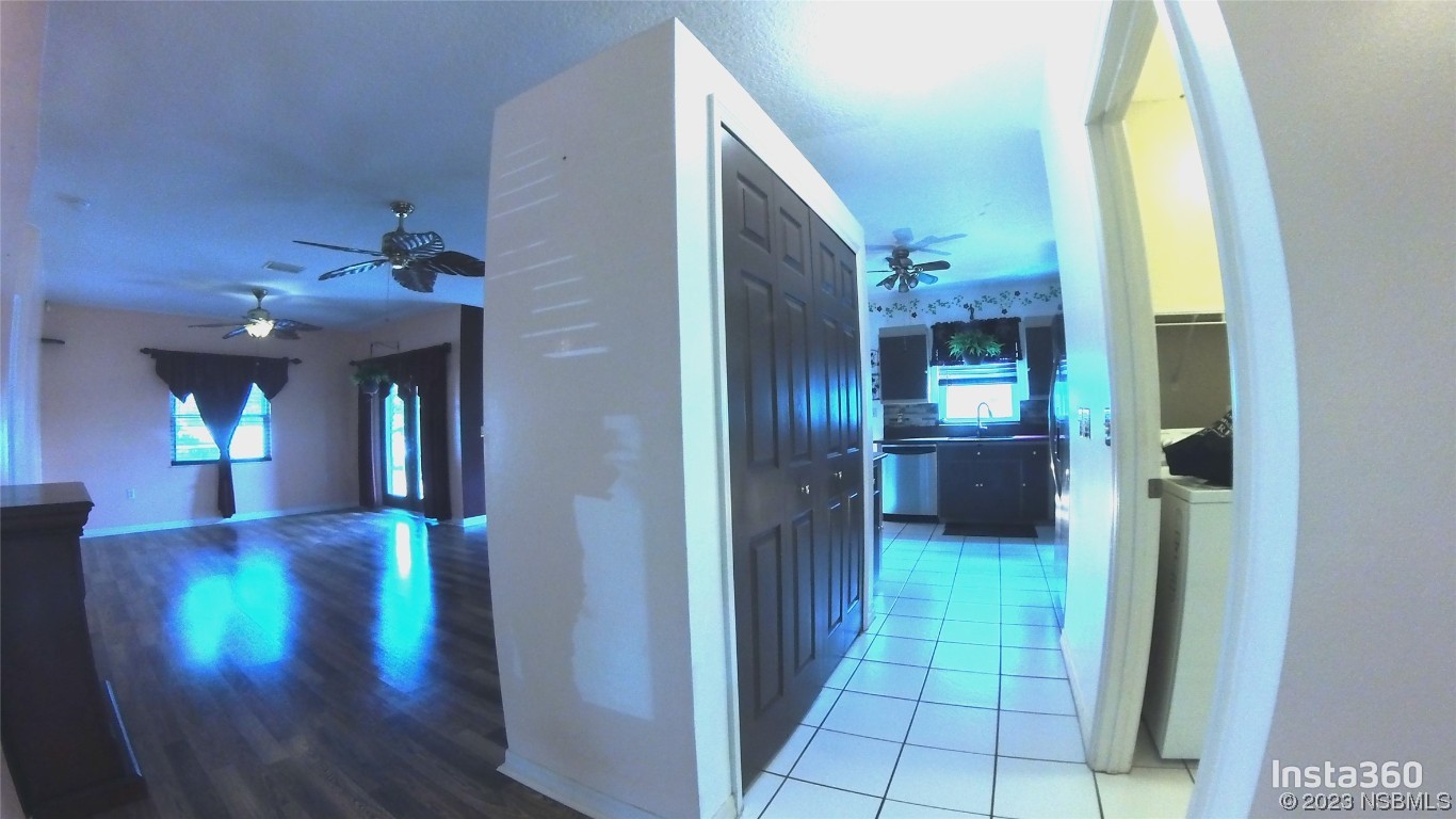 213 Falcon Avenue Edgewater, FL 32141 - Photo 15 of 44 a view of a hallway with wooden floor windows and livingroom