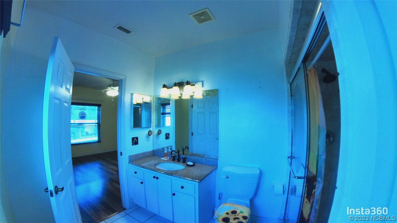 213 Falcon Avenue Edgewater, FL 32141 - Photo 19 of 44 a bathroom with a granite countertop sink a mirror and vanity