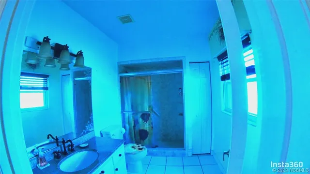 a bathroom with a sink shower and a mirror