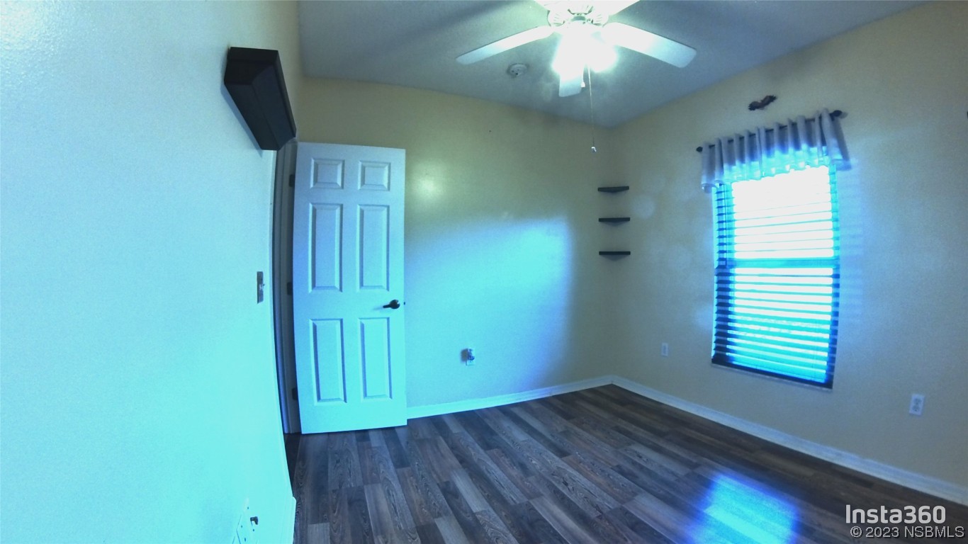 213 Falcon Avenue Edgewater, FL 32141 - Photo 21 of 44 wooden floor in an empty room with a window
