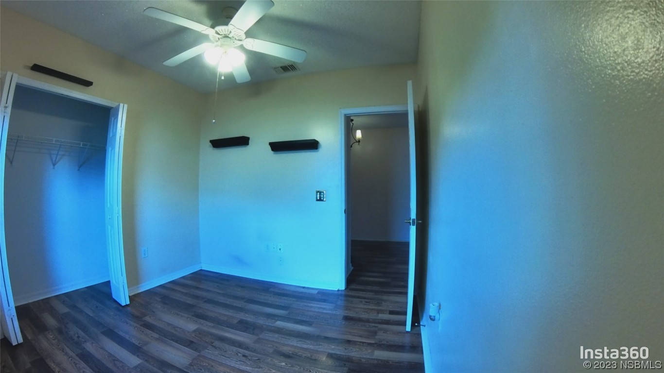 213 Falcon Avenue Edgewater, FL 32141 - Photo 22 of 44 an empty room with wooden floor and fan
