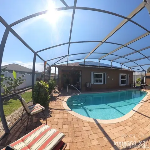 a view of a porch with furniture and a yard