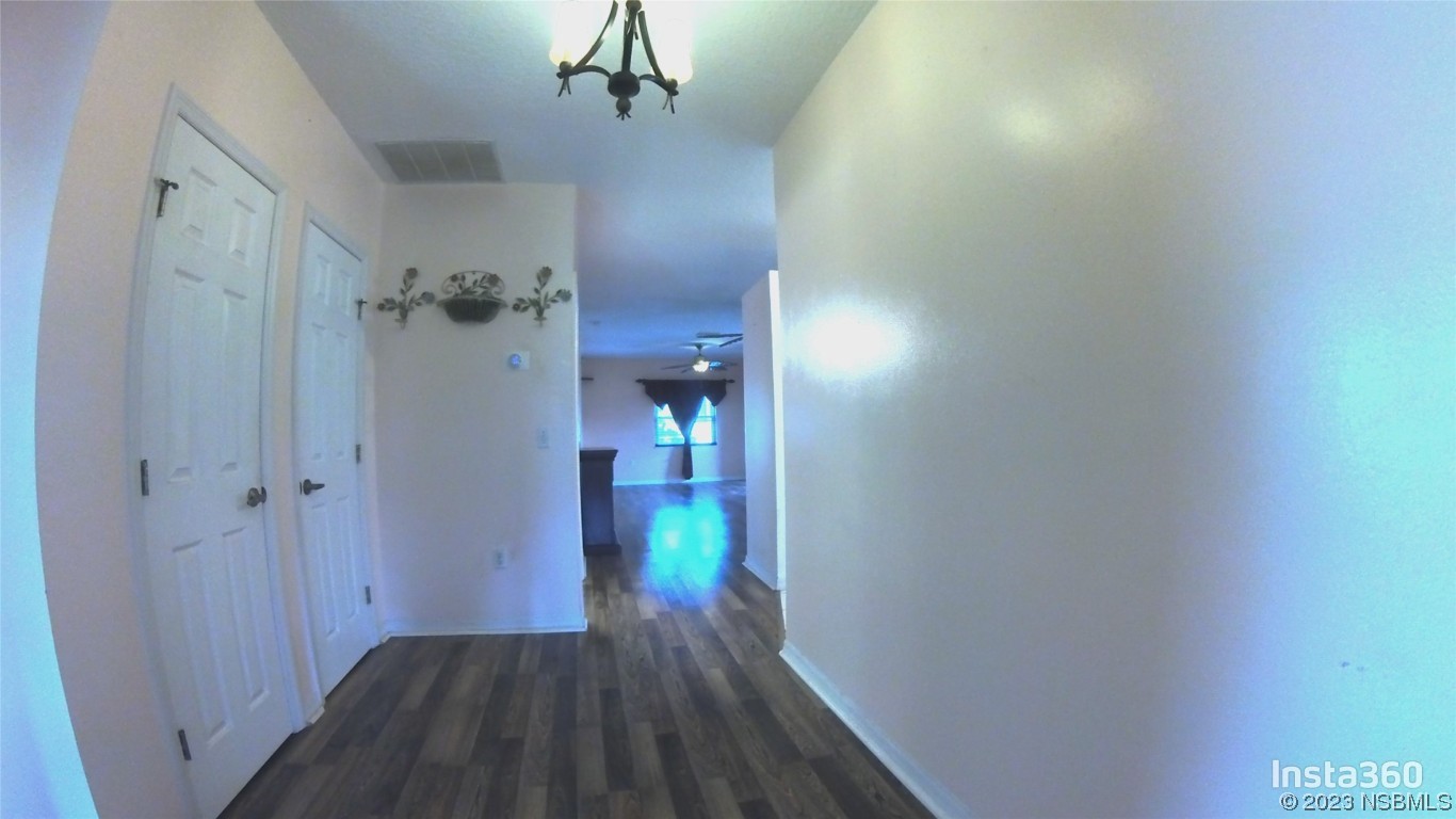 213 Falcon Avenue Edgewater, FL 32141 - Photo 4 of 44 a view of a hallway with wooden floor and closet area