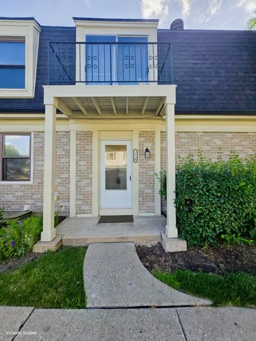 a view of a brick house with plants