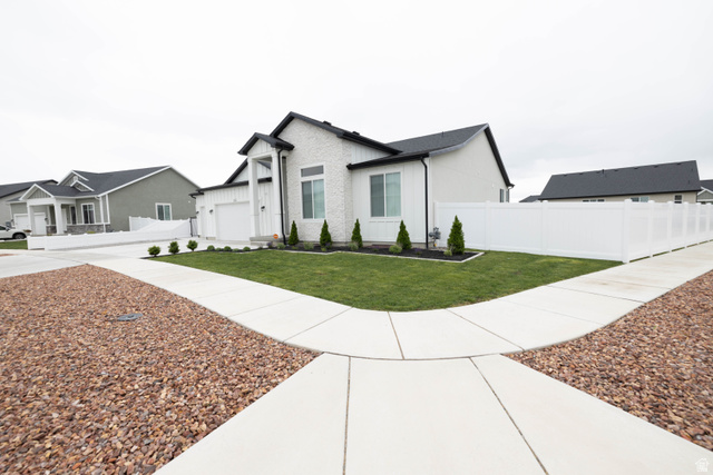 293 North Pheasant Drive Mapleton, UT 84664 - Photo 17 of 20 View of front of home with board and batten siding, driveway, and a garage