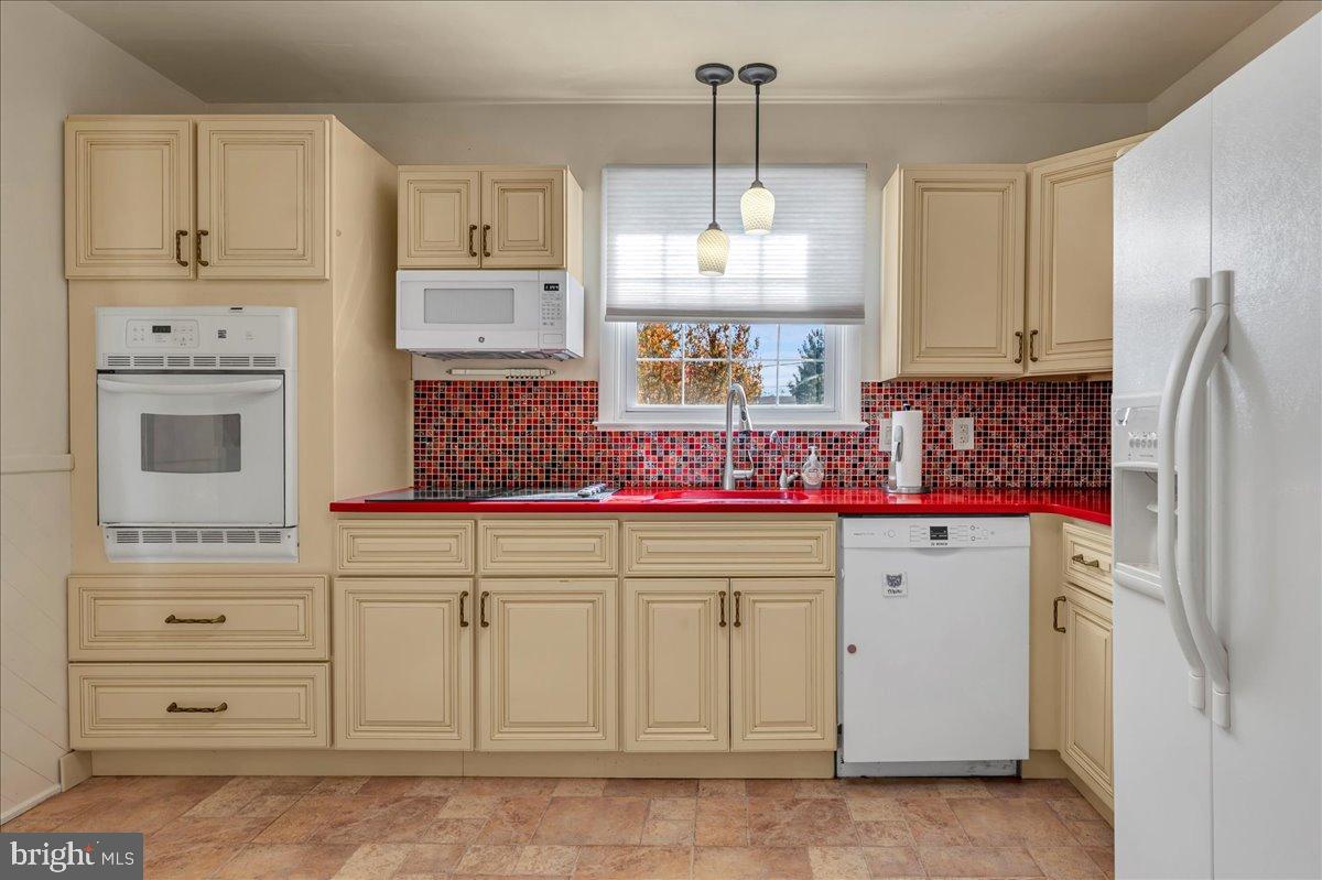 2010 Kynwyd Road Wilmington, DE 19810 - Photo 12 of 33 a kitchen with white cabinets and refrigerator