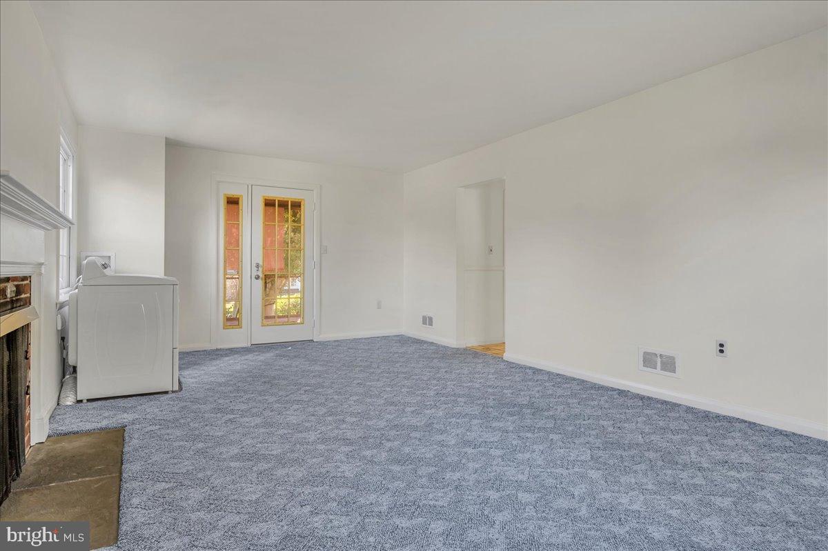 2010 Kynwyd Road Wilmington, DE 19810 - Photo 6 of 33 a view of empty room with a fireplace and windows